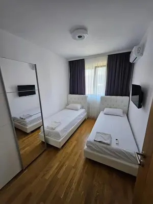 a room with two beds and a mirror at Agape Bečići Apartment in Becici