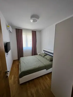 a small bedroom with a bed and a window at Agape Bečići Apartment in Becici
