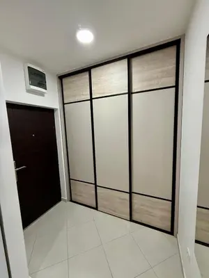 a walk in closet with sliding glass doors at Apartman Dunja Bečići in Becici