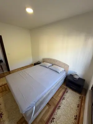 a bedroom with a bed and a night stand at Apartman Dunja Bečići in Becici