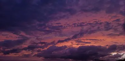 a sunset with clouds in the sky at Orange tree Residency in Bar