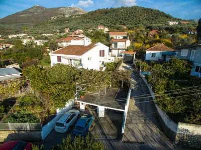 an aerial view of a town with cars parked in a parking lot at Orange tree Residency in Bar