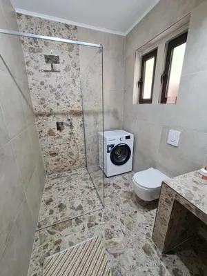 a bathroom with a shower with a toilet and a sink at Stefanelo in Ulcinj