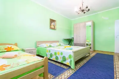a bedroom with two beds and a mirror at Stefanelo in Ulcinj