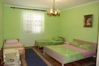 a bedroom with two beds and a chandelier at Stefanelo in Ulcinj