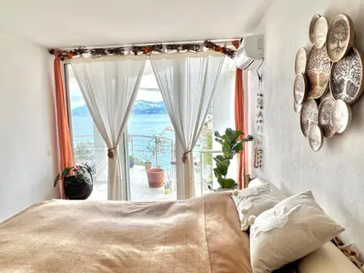 a bedroom with a bed and a large window at Hladna Uvala Apartment - 2 bedroom in Bar