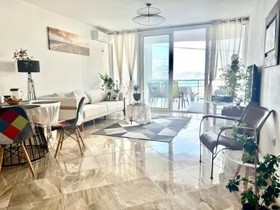 a living room with a couch and a table and chairs at Hladna Uvala Apartment - 2 bedroom in Bar