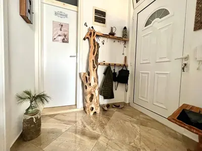 a hallway with a door with a giraffe on the wall at Hladna Uvala Apartment - 2 bedroom in Bar