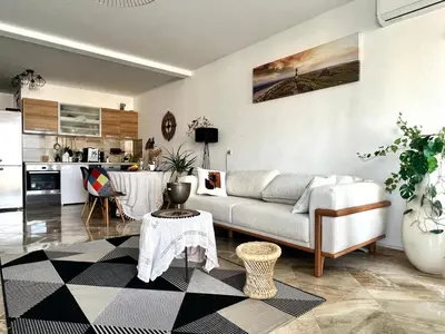 a living room with a couch and a kitchen at Hladna Uvala Apartment - 2 bedroom in Bar
