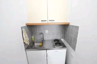 a small kitchen with a sink and white cabinets at Villa Infinity swimming pool above Saint Stephan in Andriči°i