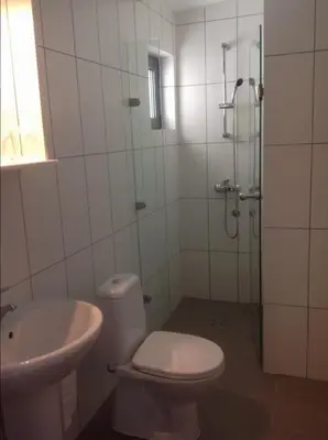 a bathroom with a shower and a toilet and a sink at Villa Infinity swimming pool above Saint Stephan in Andriči°i
