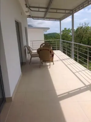 a balcony with two chairs and a bench on it at Villa Infinity swimming pool above Saint Stephan in Andriči°i