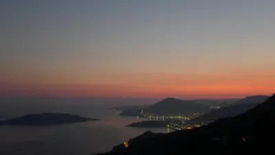 a view of a body of water at sunset at Villa Infinity swimming pool above Saint Stephan in Andriči°i