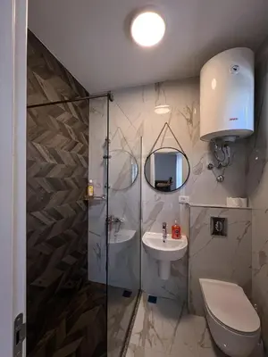 a bathroom with a shower and a toilet and a sink at Addy House in Ulcinj