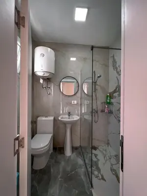 a bathroom with a toilet and a sink and a shower at Addy House in Ulcinj