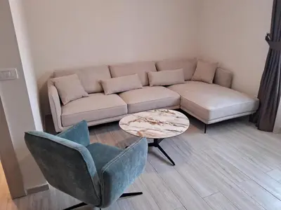 a living room with a couch and a table and a chair at Casa Oliva Apartments in Katun