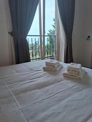 a hotel room with a bed with towels on it at Casa Oliva Apartments in Katun