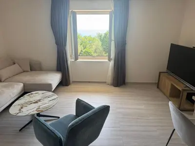a living room with a couch and chairs and a television at Casa Oliva Apartments in Katun