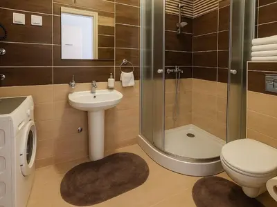 a bathroom with a shower and a toilet and a sink at Dagana in Budva