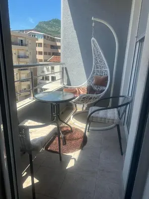 a balcony with two chairs and a table on a balcony at Dagana in Budva