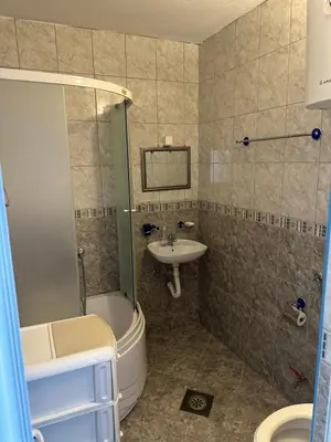 a bathroom with a sink and a shower and a toilet at Apartments Nera in Utjeha