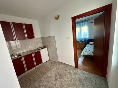 a kitchen with a door open to a bedroom at Apartments Nera in Utjeha