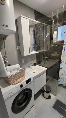 a bathroom with a washing machine and a sink at Apartman Vuk 15 in Budva