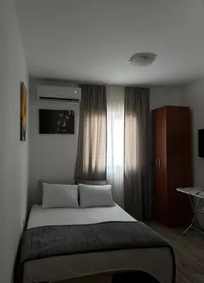 a bedroom with a bed in a room with a window at Apartments Lipa in Budva
