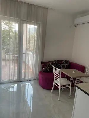 a living room with a table and a couch at Apartments Lipa in Budva