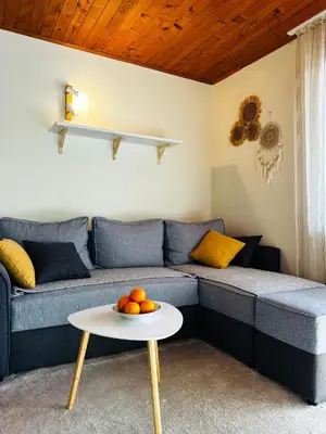 a living room with a blue couch with a table at Princess of the Beach in Sutomore