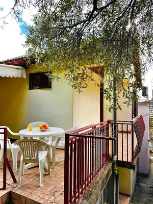 a patio with a table and chairs and a building at Princess of the Beach in Sutomore
