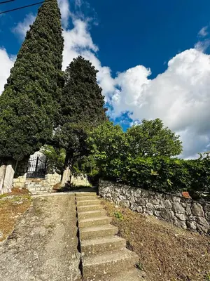 a set of stairs next to a stone wall at Princess of the Beach in Sutomore