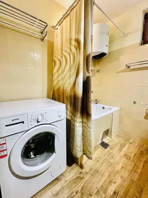 a washing machine in a bathroom with a sink at Princess of the Beach in Sutomore