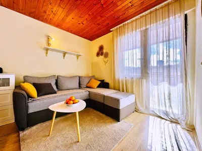 a living room with a couch and a table at Princess of the Beach in Sutomore
