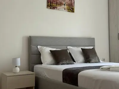 a bedroom with a bed with two pillows at Antonios Apartments in Ulcinj