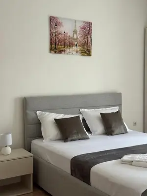 a bedroom with two beds and a picture of the eiffel tower at Antonios Apartments in Ulcinj