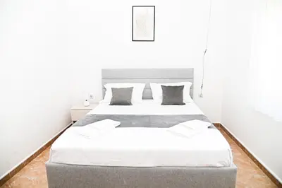 a bedroom with two beds with white walls at Antonios Apartments in Ulcinj