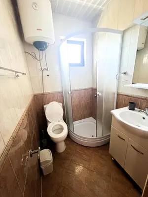 a bathroom with a shower and a toilet and a sink at Antonios Apartments in Ulcinj