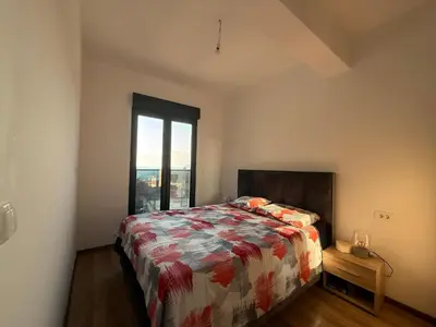 a bedroom with a bed and a large window at Veliki Pijesak One Bedroom Apartment in Dobra Voda