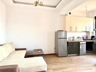 a living room with a couch and a kitchen at Veliki Pijesak One Bedroom Apartment in Dobra Voda