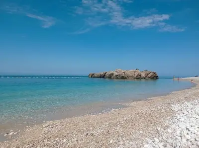 a sandy beach with rocks in the water at Veliki Pijesak One Bedroom Apartment in Dobra Voda