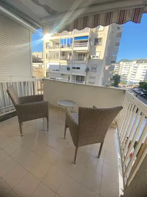 a balcony with two chairs and a table at Centar, Kosta apartment in Bar