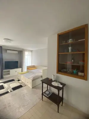 a bedroom with a bed and a table in it at Centar, Kosta apartment in Bar