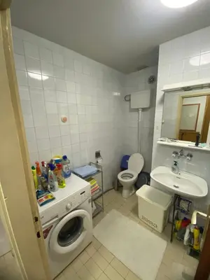 a bathroom with a washing machine and a sink at Centar, Kosta apartment in Bar