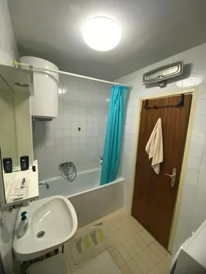 a bathroom with a sink and a tub and a shower at Centar, Kosta apartment in Bar