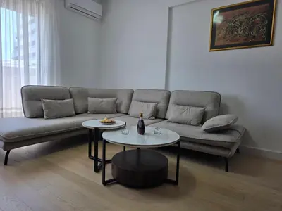 a living room with a couch and two tables at Azure Elite Apartment in Becici