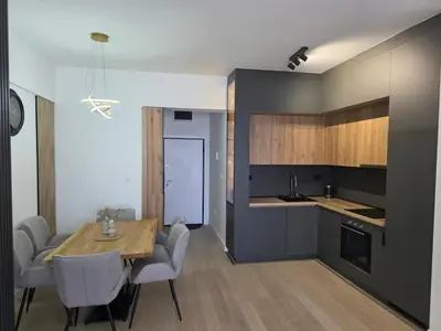 a kitchen and dining room with a table and chairs at Azure Elite Apartment in Becici
