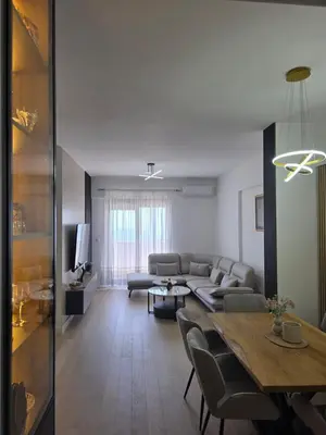 a living room with a couch and a table at Azure Elite Apartment in Becici