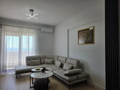 a living room with a couch and a table at Azure Elite Apartment in Becici