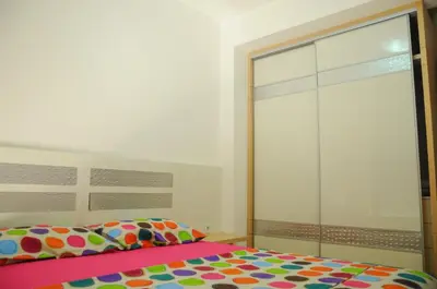 a bedroom with a bed and a sliding glass door at Andreja Apartment in Budva